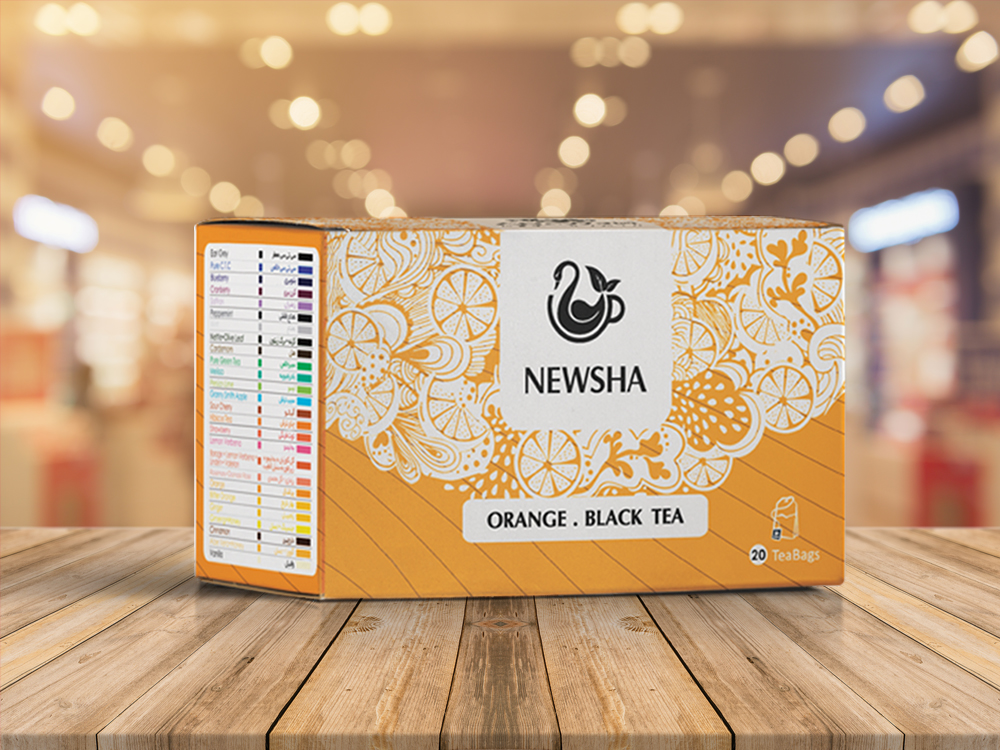A box of Newsha Orange Black Tea with 20 tea bags is displayed on a wooden surface with a blurred background.